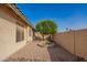 Xeriscaped backyard with a small seating area around a shade tree for outdoor relaxation at 462 S Marie Dr, Chandler, AZ 85225