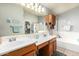 Bathroom featuring dual sinks, vanity, and separate tub and shower at 462 S Marie Dr, Chandler, AZ 85225