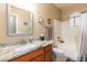 Well-lit bathroom features a granite countertop vanity, framed mirror, and a shower-tub combination at 462 S Marie Dr, Chandler, AZ 85225