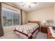 Cozy bedroom featuring a large window, ceiling fan, neutral paint and carpet flooring at 462 S Marie Dr, Chandler, AZ 85225