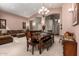 Elegant dining area adjacent to the living room with a large table, chandelier, and comfortable seating at 462 S Marie Dr, Chandler, AZ 85225