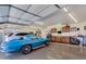 Spacious garage featuring polished floors, a blue Corvette, and ample cabinet storage at 462 S Marie Dr, Chandler, AZ 85225