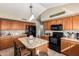 Traditional kitchen featuring wooden cabinets, granite counters, kitchen island and black appliances at 462 S Marie Dr, Chandler, AZ 85225