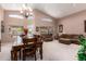 Bright living room with vaulted ceilings, large windows, and elegant chandelier providing an airy atmosphere at 462 S Marie Dr, Chandler, AZ 85225