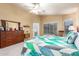 Spacious main bedroom with dual windows, neutral paint, ceiling fan and large dresser at 462 S Marie Dr, Chandler, AZ 85225
