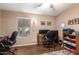 Home office features a ceiling fan, wood floors, window with blinds, two desks, and shelving at 462 S Marie Dr, Chandler, AZ 85225