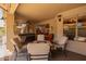 Cozy covered patio boasts comfortable seating around a fire pit and a relaxing hot tub at 462 S Marie Dr, Chandler, AZ 85225