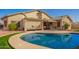 Beautiful backyard pool with lush grass, desert landscaping, and outdoor seating and shade at 462 S Marie Dr, Chandler, AZ 85225