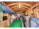 Organized storage shed with bright green carpet, wooden walls, and various storage solutions for tools and equipment at 462 S Marie Dr, Chandler, AZ 85225