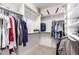 Large walk-in closet with custom shelving and hanging storage and carpet flooring at 462 S Marie Dr, Chandler, AZ 85225