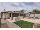 Expansive backyard with a built-in kitchen, covered patio, pool, and artificial turf, ideal for entertaining at 5605 N 19Th St, Phoenix, AZ 85016