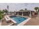 Spacious backyard with a pool, spa, covered patio, and outdoor kitchen, perfect for relaxation and recreation at 5605 N 19Th St, Phoenix, AZ 85016
