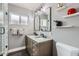 Modern bathroom with double vanity, sleek mirrors, stylish fixtures, and tiled shower with glass door at 5605 N 19Th St, Phoenix, AZ 85016