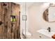 Stylish bathroom featuring a wood-paneled shower, modern vanity, and frameless glass partition at 5605 N 19Th St, Phoenix, AZ 85016