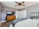 Calm bedroom with wood-look floors, a ceiling fan, closet, and dresser with large television at 5605 N 19Th St, Phoenix, AZ 85016