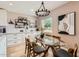 Elegant dining area with a glass table, stylish chandelier, and contemporary decor at 5605 N 19Th St, Phoenix, AZ 85016
