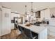 Modern kitchen boasts stainless steel appliances, white cabinets, a waterfall island, and stylish bar stools at 5605 N 19Th St, Phoenix, AZ 85016