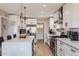 Well-lit kitchen with white cabinets, stainless appliances, a waterfall island, and modern barstools at 5605 N 19Th St, Phoenix, AZ 85016
