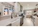 Updated kitchen featuring white cabinetry, stainless steel appliances, and a farmhouse sink under a window at 5605 N 19Th St, Phoenix, AZ 85016