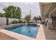 Sparkling pool and spa surrounded by a paved patio and lush greenery, creating a serene backyard oasis at 5605 N 19Th St, Phoenix, AZ 85016