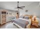 Bedroom featuring a large bed, ceiling fan, wood floors, and a bright window at 5830 E Mckellips Rd # 30, Mesa, AZ 85215