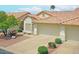 Charming single-story home featuring a tile roof, two-car garage, and low-maintenance desert landscaping at 5830 E Mckellips Rd # 30, Mesa, AZ 85215