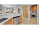 Bright kitchen with stainless steel dishwasher, tan cabinets, and stone countertops, breakfast nook, laundry room at 5830 E Mckellips Rd # 30, Mesa, AZ 85215