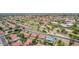 Overhead view of houses in a neighborhood full of mature trees, featuring a community area and multiple swimming pools at 6019 E Paradise Ln, Scottsdale, AZ 85254