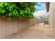 Fenced backyard with a gravel area and access gate at 6019 E Paradise Ln, Scottsdale, AZ 85254