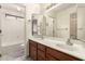 Well-lit bathroom featuring a double sink vanity and a shower-tub combo at 6019 E Paradise Ln, Scottsdale, AZ 85254
