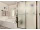 Bathroom featuring a tub and a glass-enclosed shower, with a neutral tile design at 6019 E Paradise Ln, Scottsdale, AZ 85254