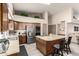 Kitchen with wooden cabinets, a center island, stainless steel appliances, and high ceilings at 6019 E Paradise Ln, Scottsdale, AZ 85254
