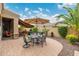Expansive backyard with an outdoor dining area, shaded lounge, and beautiful landscaping perfect for relaxation at 6202 E Mckellips Rd # 189, Mesa, AZ 85215