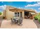 Spacious backyard featuring an outdoor dining area, shaded lounge area, and lush greenery for ultimate outdoor enjoyment at 6202 E Mckellips Rd # 189, Mesa, AZ 85215