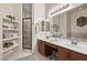 Bright bathroom with double sinks, vanity area, and glass-enclosed shower, plus open shelving at 6202 E Mckellips Rd # 189, Mesa, AZ 85215