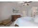 Spacious bedroom featuring a large dresser, TV, comfortable ottoman, and walk-in closet at 6202 E Mckellips Rd # 189, Mesa, AZ 85215