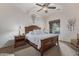 Comfortable primary bedroom with a wooden bed frame, plush carpet, and a large window at 6202 E Mckellips Rd # 189, Mesa, AZ 85215