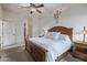 Cozy bedroom with a well-made wooden bed frame and carpet floors plus an open door at 6202 E Mckellips Rd # 189, Mesa, AZ 85215