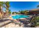 Inviting community pool surrounded by lounge chairs, lush palm trees, and a beautiful clubhouse at 6202 E Mckellips Rd # 189, Mesa, AZ 85215