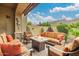 Charming covered patio with cozy seating around a fire pit, complemented by lush greenery and a peaceful ambiance at 6202 E Mckellips Rd # 189, Mesa, AZ 85215