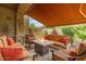 Inviting covered patio featuring a fire pit, comfortable seating, and a decorative outdoor wall at 6202 E Mckellips Rd # 189, Mesa, AZ 85215