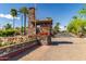 Elegant community entrance featuring a stone gatehouse, manicured landscaping, and welcoming signage at 6202 E Mckellips Rd # 189, Mesa, AZ 85215