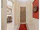 View of the home's foyer, featuring tile flooring, a wood entry door, neutral paint, and a glimpse into the dining area at 6202 E Mckellips Rd # 189, Mesa, AZ 85215