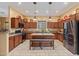Spacious kitchen featuring custom cabinets, stainless steel appliances, granite countertops, and a center island with bench seating at 6202 E Mckellips Rd # 189, Mesa, AZ 85215