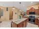 Open-concept kitchen island with granite countertops, seating, and views of the eat-in dining room at 6202 E Mckellips Rd # 189, Mesa, AZ 85215