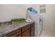 Well-lit laundry room with countertop, wooden cabinets, modern washer and dryer, and neatly stacked towels at 6202 E Mckellips Rd # 189, Mesa, AZ 85215