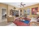 Comfortable living room featuring neutral furnishings, a ceiling fan, and seamless access to the outdoors at 6202 E Mckellips Rd # 189, Mesa, AZ 85215