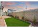 A fenced backyard with synthetic grass and desert landscaping at 630 W Laredo St, Chandler, AZ 85225