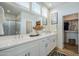 Bright bathroom with double vanity, walk-in closet, glass shower, and decor providing a refreshing and inviting experience at 630 W Laredo St, Chandler, AZ 85225