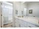 Bright bathroom features a white vanity with drawers and cabinets, with a shower and tub behind at 630 W Laredo St, Chandler, AZ 85225